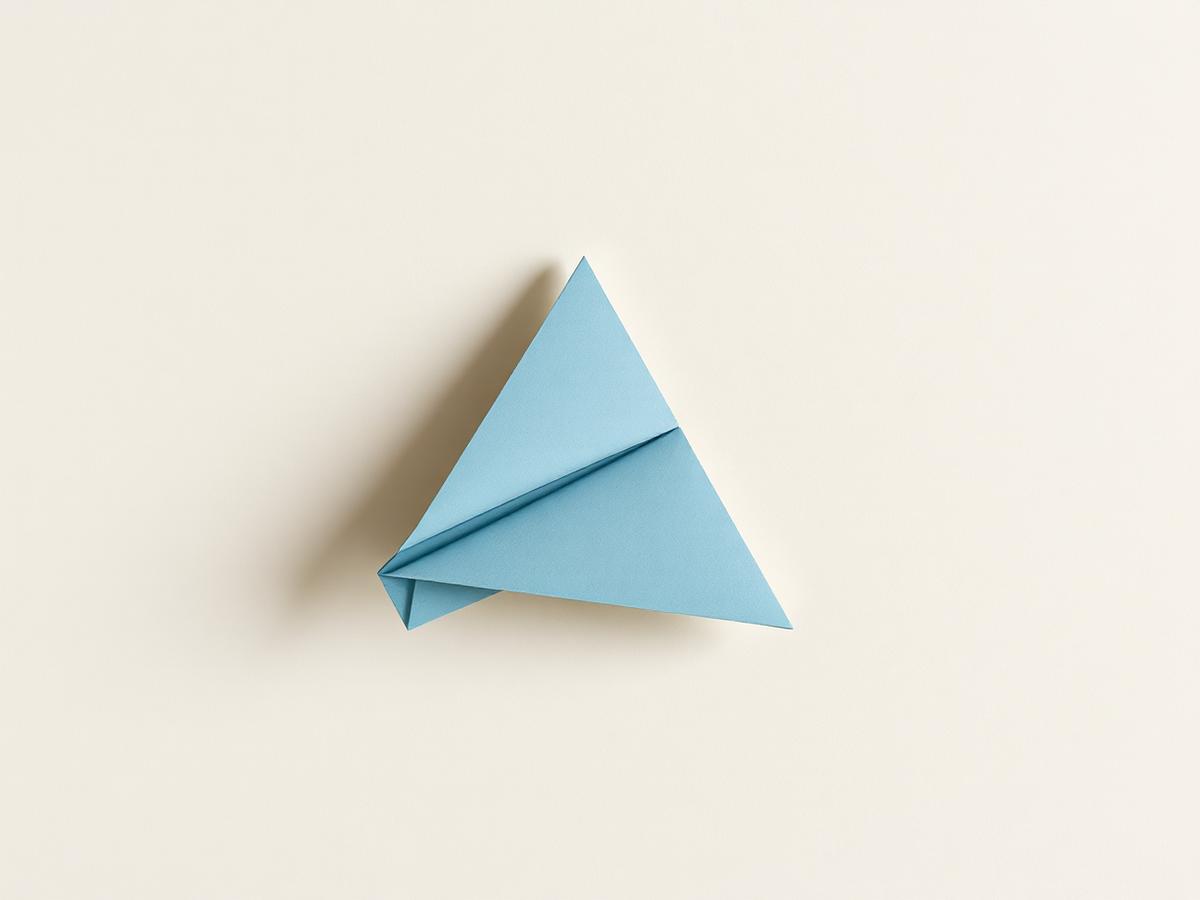 Folded blue paper aeroplane